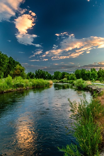 body of water under blue sky